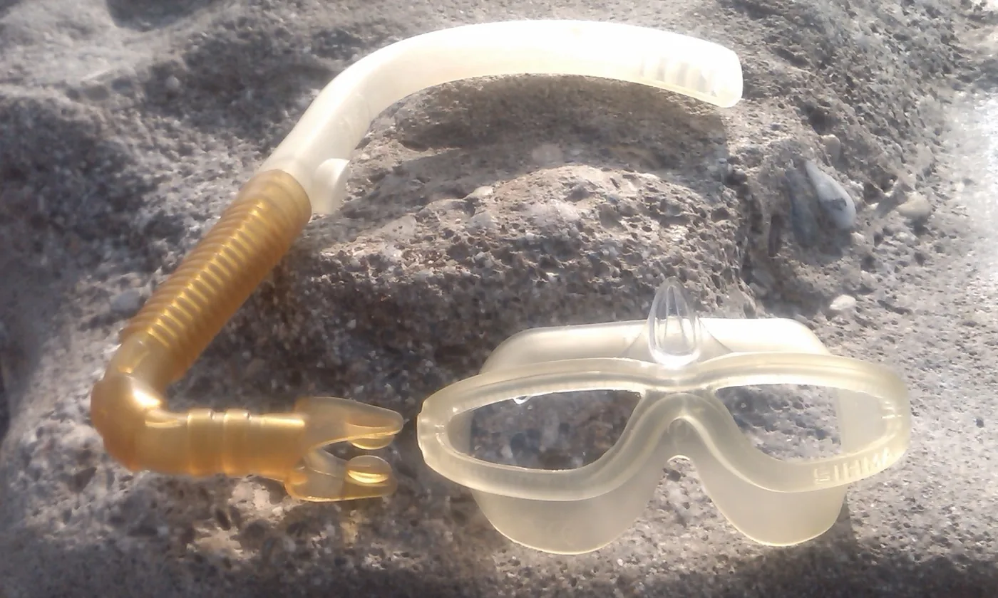 SIHMA mask and snorkel functional prototype photographed on beach pebbles