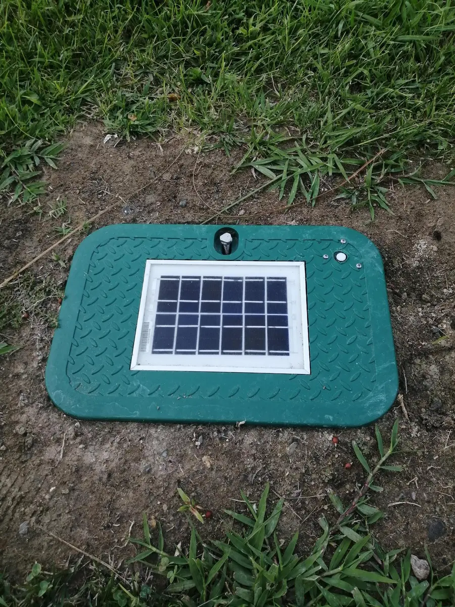 Smart irrigation valve box lid with integrated solar panel installed in the ground in southern Spain