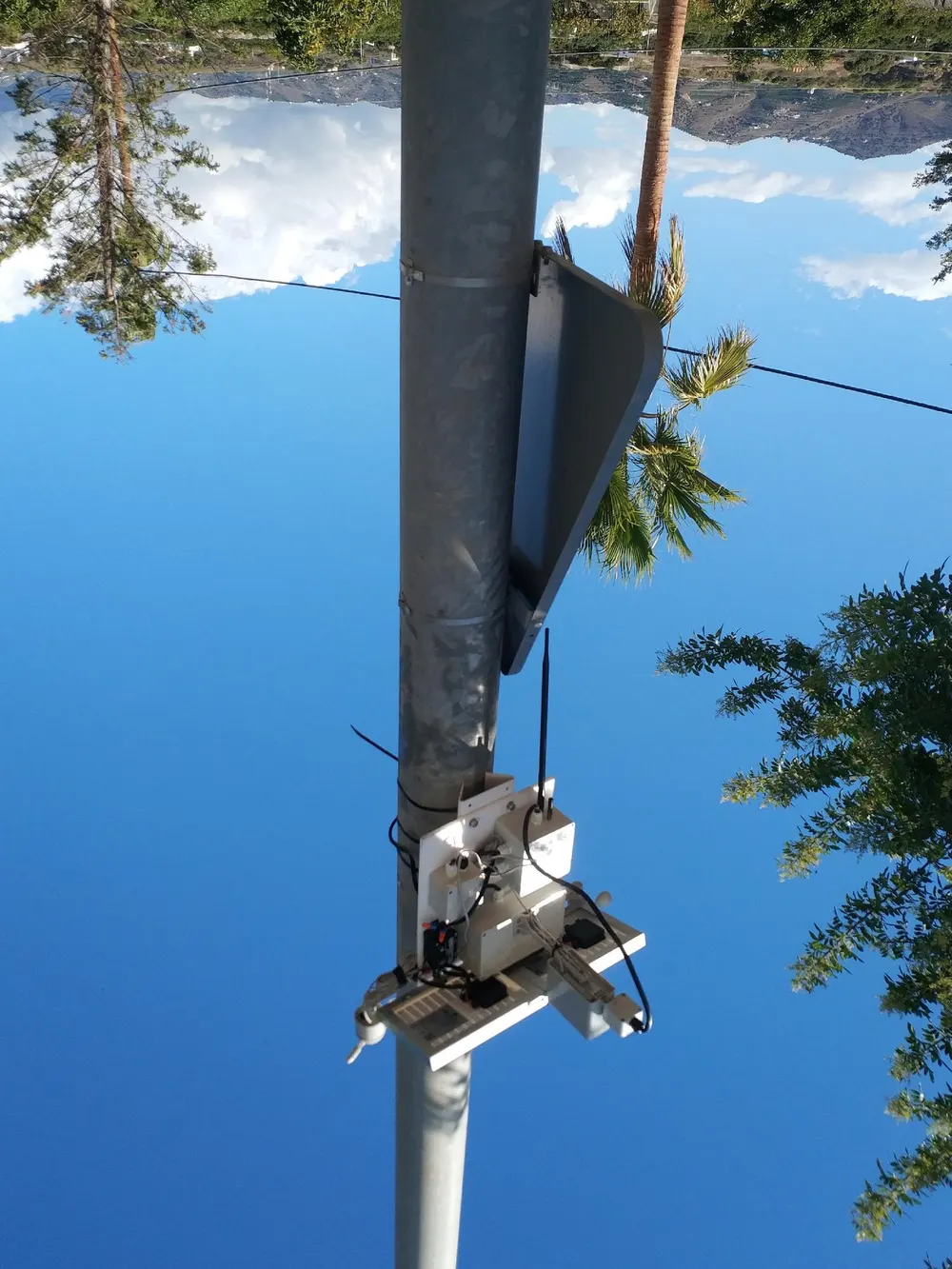 Weather station and communications equipment installed on a pole with the Costa del Sol landscape behind